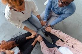 People holding hands working together for sobriety.